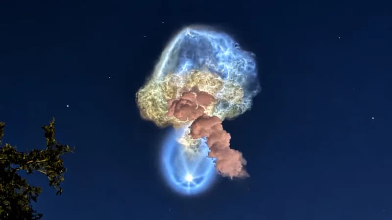 A glowing, jellyfish-shaped rocket plume in the predawn sky over Florida, with a small round blue glow at its base
